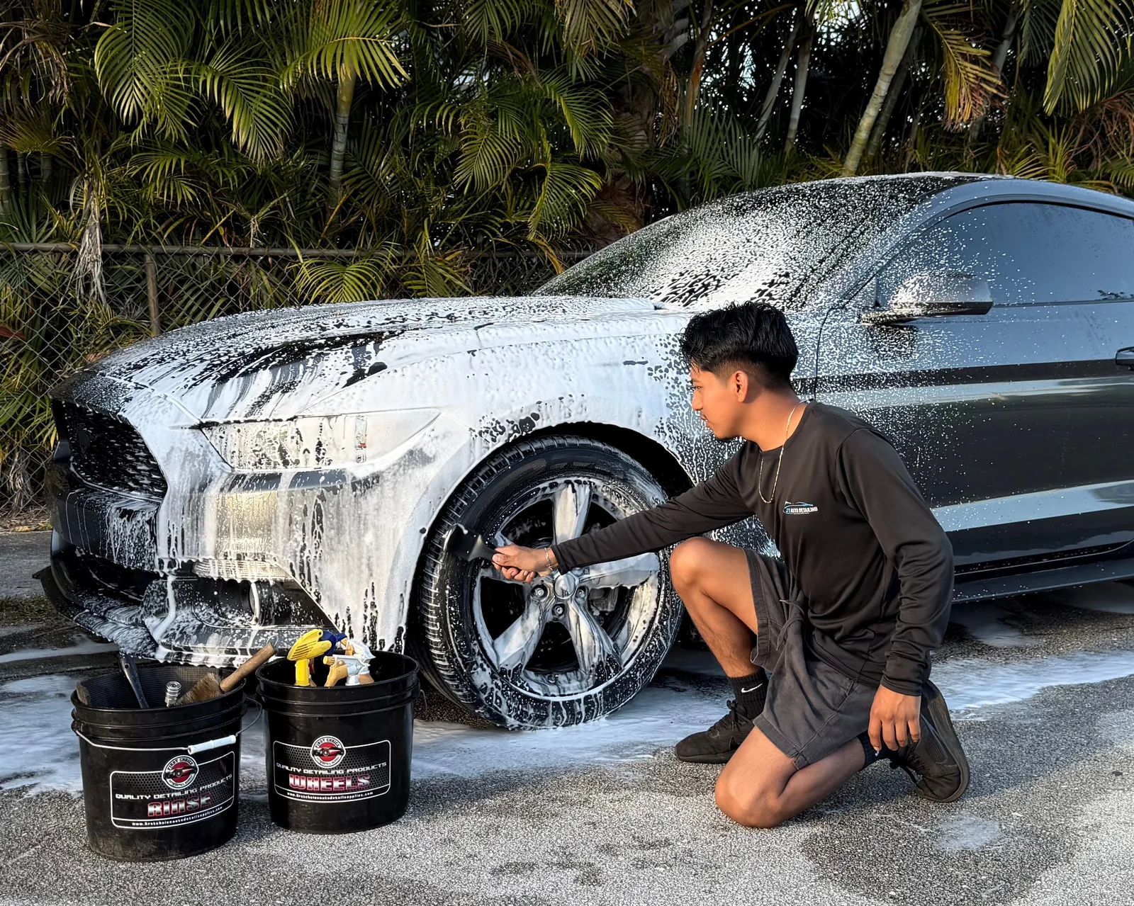 Jay, owner of J's Car Detailing, hand-washing a Ford Mustang in West Palm Beach, Florida